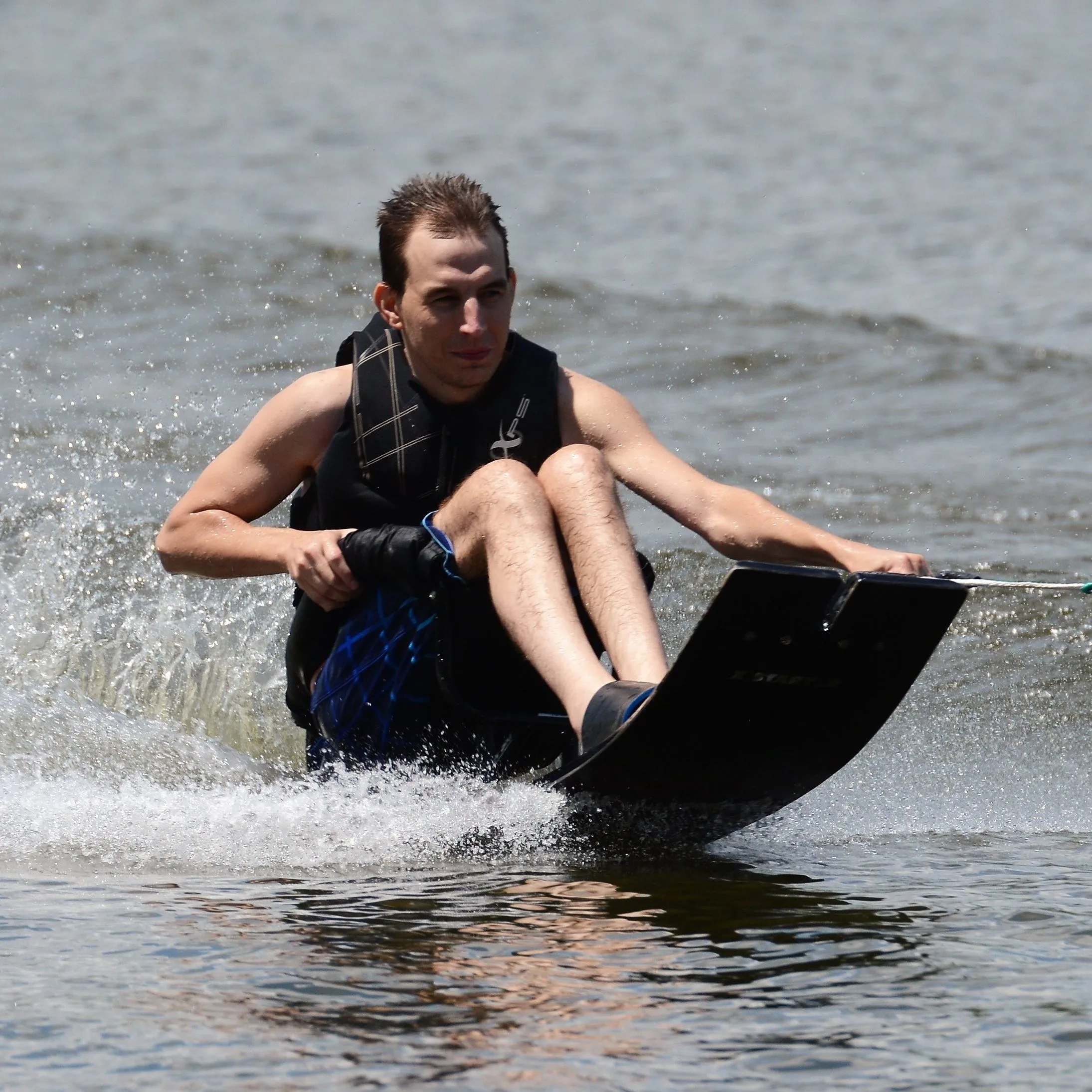 young male sit skiing